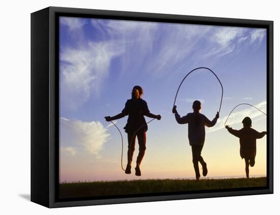 Silhouette of Children Jumping Rope Outdoors-Mitch Diamond-Framed Premier Image Canvas