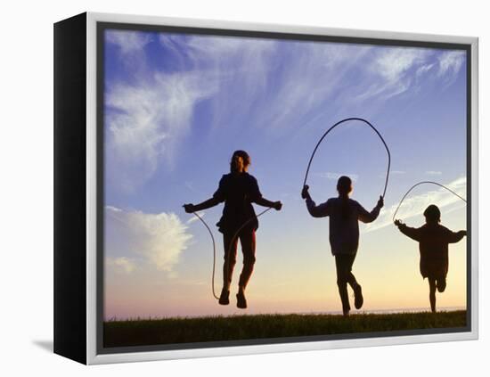 Silhouette of Children Jumping Rope Outdoors-Mitch Diamond-Framed Premier Image Canvas