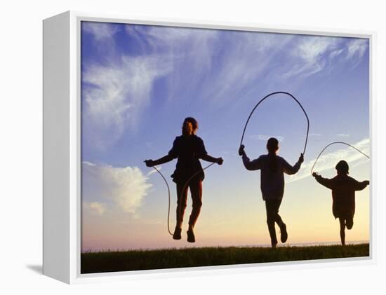 Silhouette of Children Jumping Rope Outdoors-Mitch Diamond-Framed Premier Image Canvas