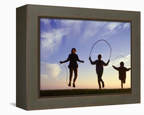 Silhouette of Children Jumping Rope Outdoors-Mitch Diamond-Framed Premier Image Canvas