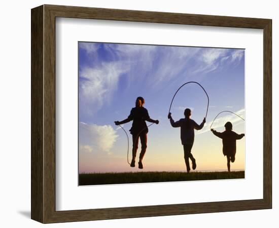 Silhouette of Children Jumping Rope Outdoors-Mitch Diamond-Framed Photographic Print