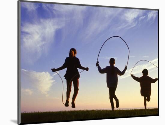 Silhouette of Children Jumping Rope Outdoors-Mitch Diamond-Mounted Photographic Print