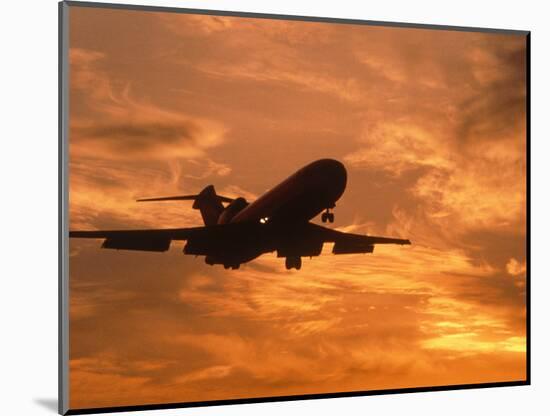 Silhouette of Commercial Airplane at Sunset-Mitch Diamond-Mounted Photographic Print