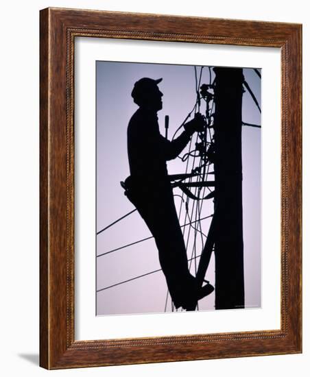 Silhouette of Engineer Working up a Telegraph Pole, East Sussex, England, United Kingdom-Ruth Tomlinson-Framed Photographic Print