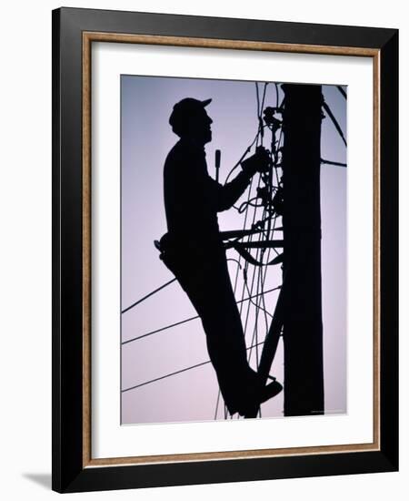 Silhouette of Engineer Working up a Telegraph Pole, East Sussex, England, United Kingdom-Ruth Tomlinson-Framed Photographic Print