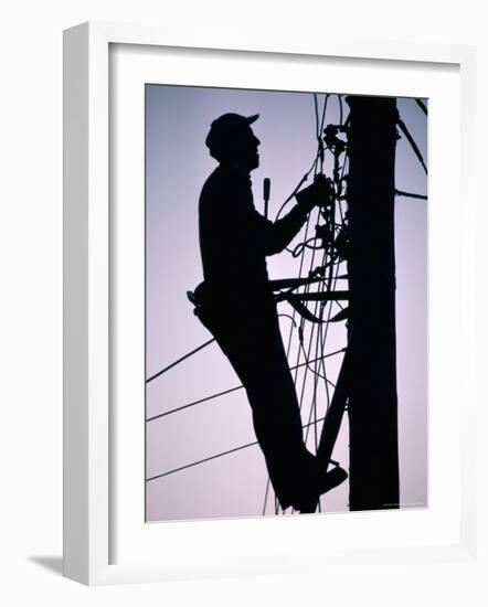 Silhouette of Engineer Working up a Telegraph Pole, East Sussex, England, United Kingdom-Ruth Tomlinson-Framed Photographic Print