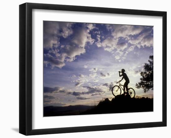 Silhouette of Mountain Biker Drinking at the Summit During Sunset-null-Framed Photographic Print