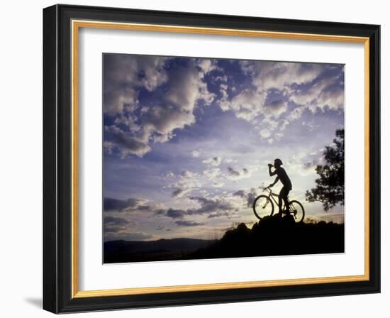 Silhouette of Mountain Biker Drinking at the Summit During Sunset-null-Framed Photographic Print