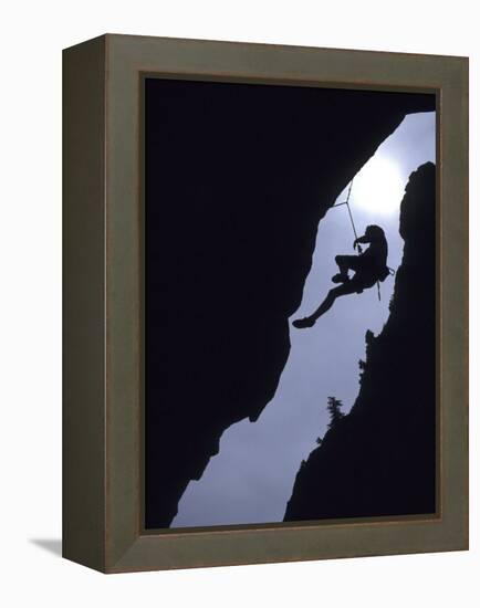 Silhouette of Rock Climber Hanging from Cliff Face-null-Framed Premier Image Canvas