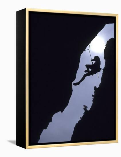 Silhouette of Rock Climber Hanging from Cliff Face-null-Framed Premier Image Canvas