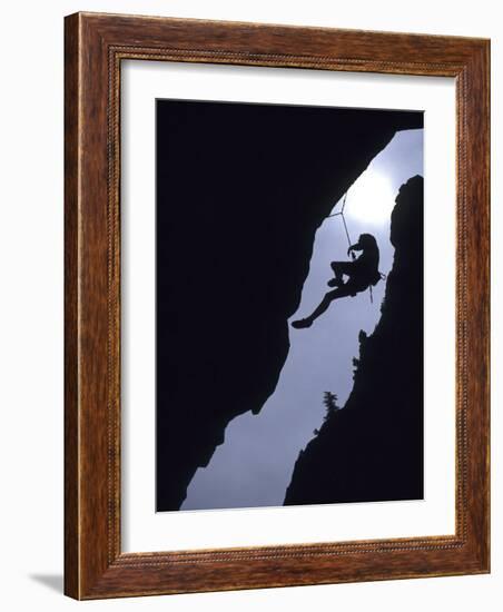 Silhouette of Rock Climber Hanging from Cliff Face-null-Framed Photographic Print