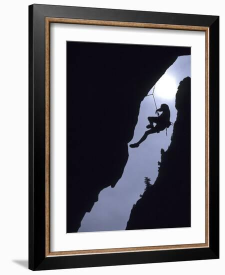 Silhouette of Rock Climber Hanging from Cliff Face-null-Framed Photographic Print