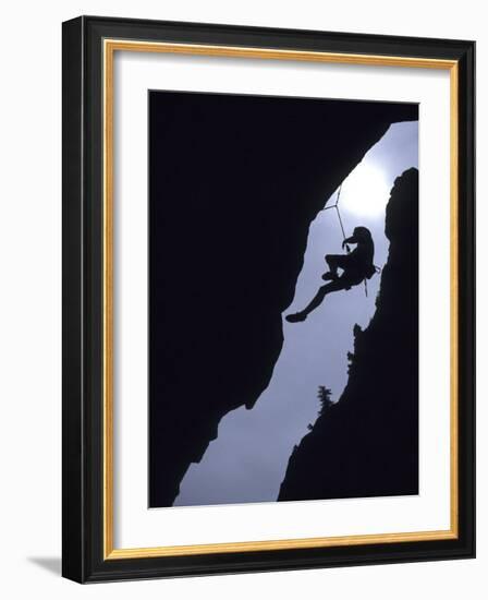 Silhouette of Rock Climber Hanging from Cliff Face-null-Framed Photographic Print