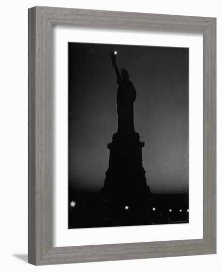 Silhouette of Statue of Liberty Lit by Two 200 Watt Lamps During Wartime Effort to Conserve Energy-Andreas Feininger-Framed Photographic Print