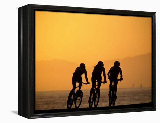 Silhouette of Three Men Riding on the Beach-Mitch Diamond-Framed Premier Image Canvas