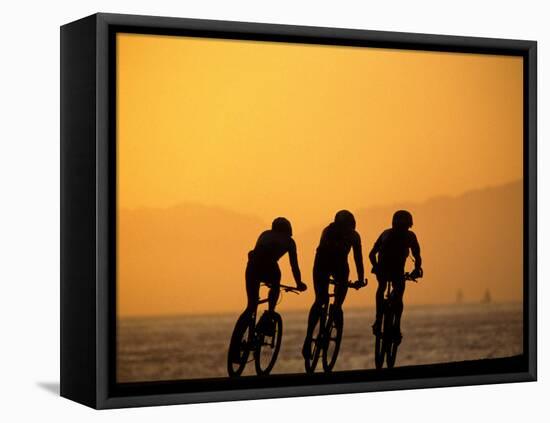 Silhouette of Three Men Riding on the Beach-Mitch Diamond-Framed Premier Image Canvas