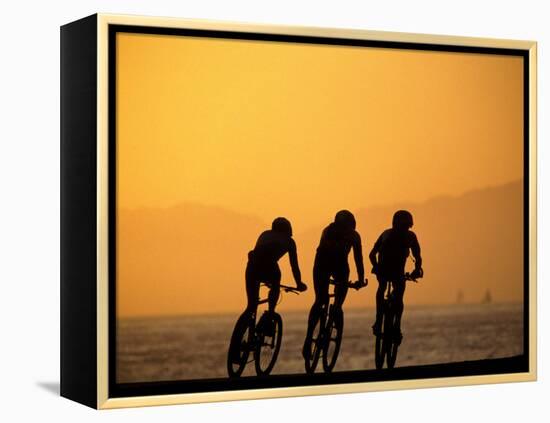 Silhouette of Three Men Riding on the Beach-Mitch Diamond-Framed Premier Image Canvas