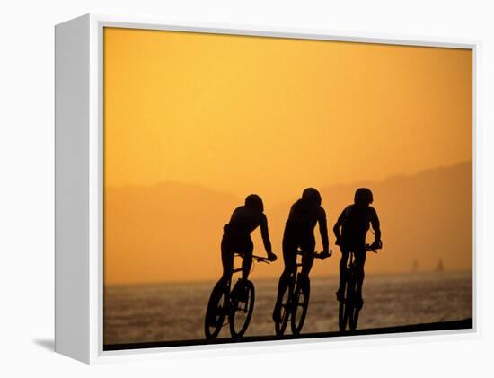 Silhouette of Three Men Riding on the Beach-Mitch Diamond-Framed Premier Image Canvas