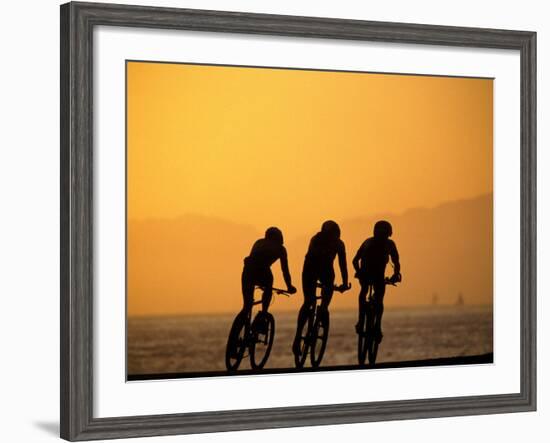 Silhouette of Three Men Riding on the Beach-Mitch Diamond-Framed Photographic Print