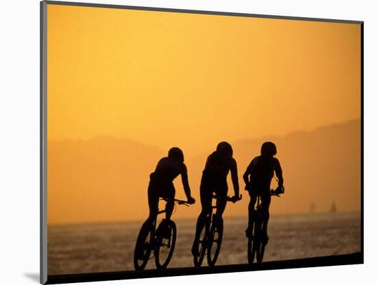 Silhouette of Three Men Riding on the Beach-Mitch Diamond-Mounted Photographic Print