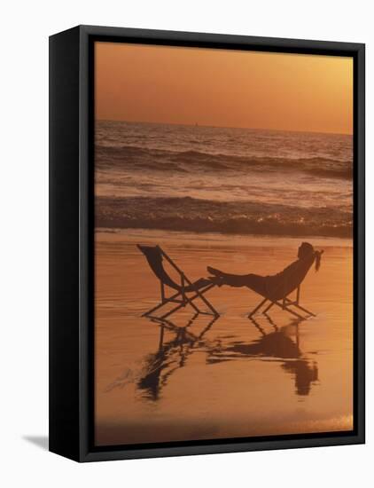 Silhouette of Woman in Beach Chair on the Beach-Mitch Diamond-Framed Premier Image Canvas