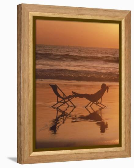 Silhouette of Woman in Beach Chair on the Beach-Mitch Diamond-Framed Premier Image Canvas