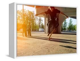 Silhouette Skateboarder Jumping in City on Skateboard under the Bridge. in the Background Two Young-Maxim Blinkov-Framed Premier Image Canvas