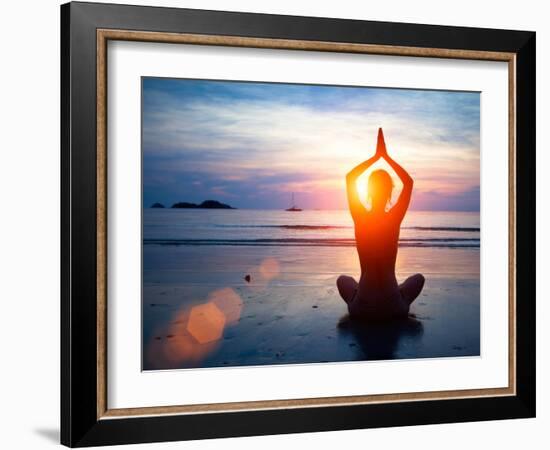 Silhouette Young Woman Practicing Yoga on the Beach at Sunset.-De Visu-Framed Photographic Print