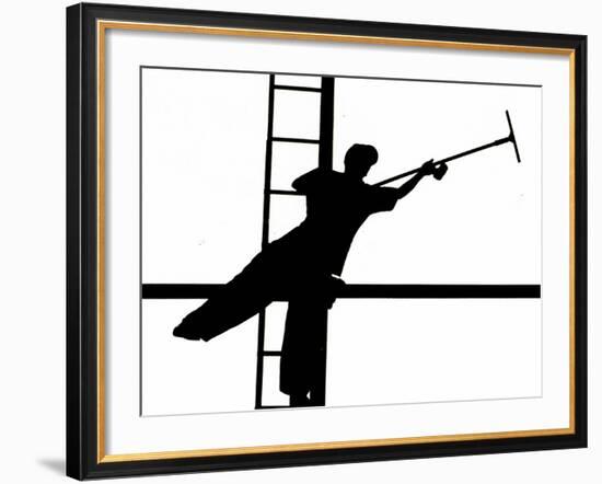 Silhouetted against the Bright Morning Sun, a Window Cleaner Stretches to Clean a Spot-null-Framed Photographic Print