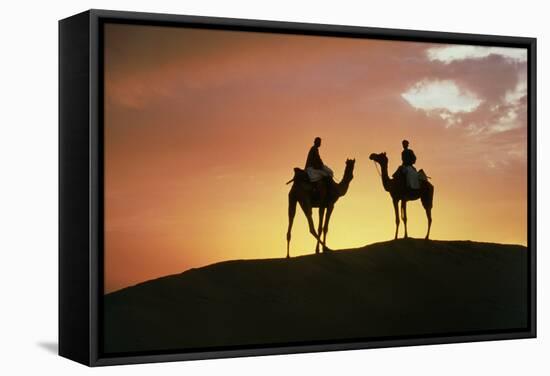 Silhouetted Camel Riders on a Sand Dune At Sunset-Tony Craddock-Framed Premier Image Canvas