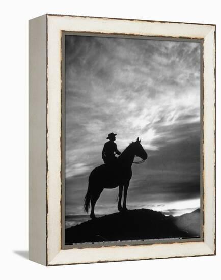 Silhouettes of Cowboy Mounted on Horse-Allan Grant-Framed Premier Image Canvas