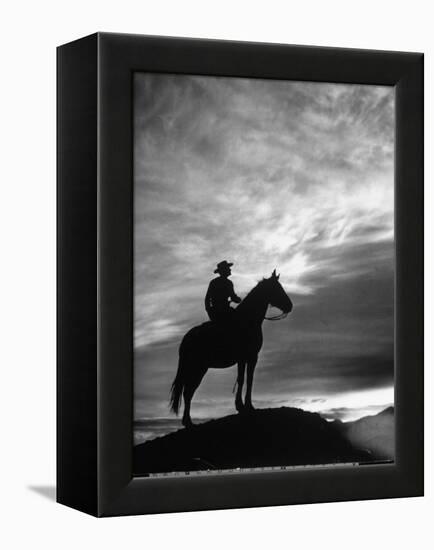 Silhouettes of Cowboy Mounted on Horse-Allan Grant-Framed Premier Image Canvas