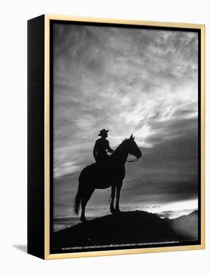 Silhouettes of Cowboy Mounted on Horse-Allan Grant-Framed Premier Image Canvas