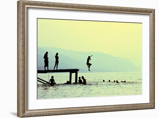 Silhouettes of Kids Who Jump off Dock on the Lake at Sunset.-Mita Stock Images-Framed Photographic Print