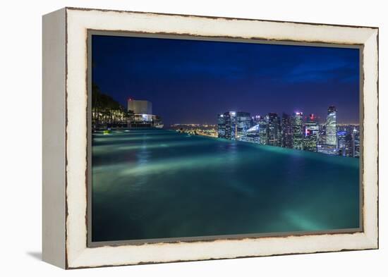 Singapore, Rooftop Swimming Pool at Dusk Overlooks the City-Walter Bibikow-Framed Premier Image Canvas