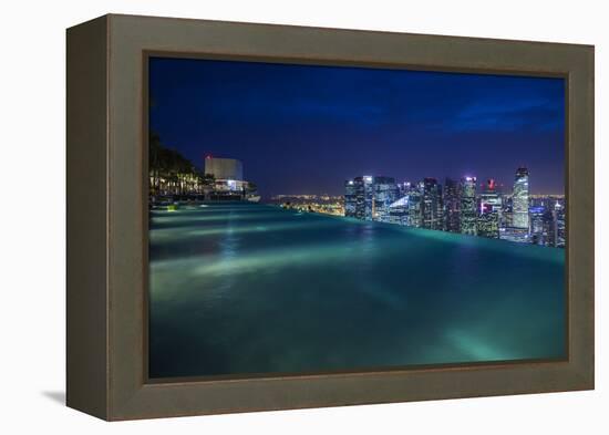 Singapore, Rooftop Swimming Pool at Dusk Overlooks the City-Walter Bibikow-Framed Premier Image Canvas