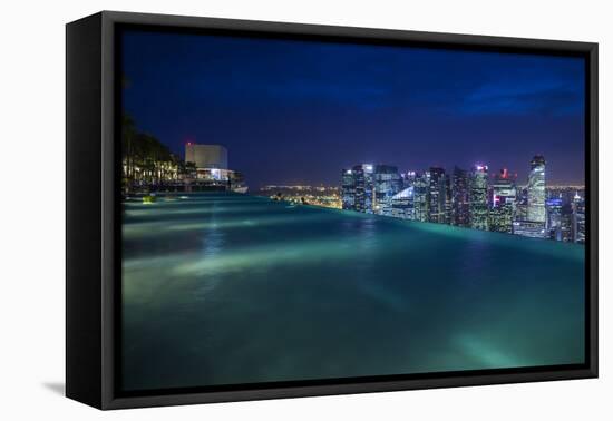 Singapore, Rooftop Swimming Pool at Dusk Overlooks the City-Walter Bibikow-Framed Premier Image Canvas