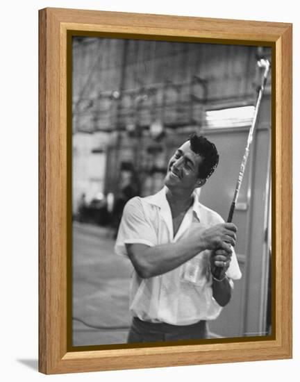 Singer and Actor Dean Martin holding a pitching club on Movie Set for MGM's "Some Came Running"-Allan Grant-Framed Premier Image Canvas