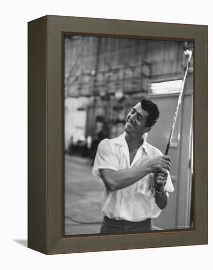 Singer and Actor Dean Martin holding a pitching club on Movie Set for MGM's "Some Came Running"-Allan Grant-Framed Premier Image Canvas