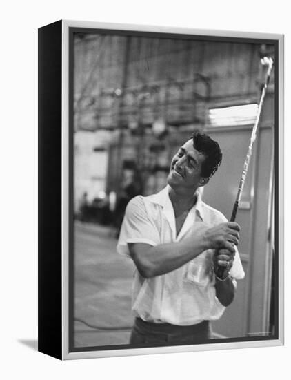 Singer and Actor Dean Martin holding a pitching club on Movie Set for MGM's "Some Came Running"-Allan Grant-Framed Premier Image Canvas