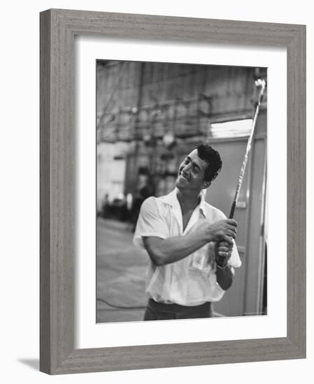 Singer and Actor Dean Martin holding a pitching club on Movie Set for MGM's "Some Came Running"-Allan Grant-Framed Premium Photographic Print