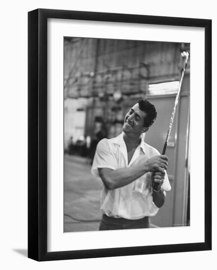 Singer and Actor Dean Martin holding a pitching club on Movie Set for MGM's "Some Came Running"-Allan Grant-Framed Premium Photographic Print