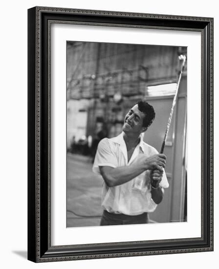 Singer and Actor Dean Martin holding a pitching club on Movie Set for MGM's "Some Came Running"-Allan Grant-Framed Premium Photographic Print