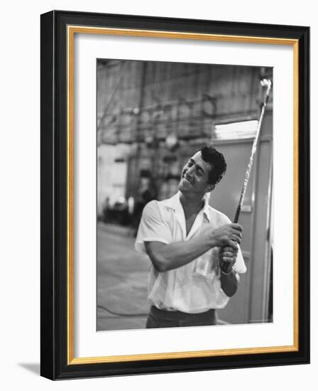 Singer and Actor Dean Martin holding a pitching club on Movie Set for MGM's "Some Came Running"-Allan Grant-Framed Premium Photographic Print