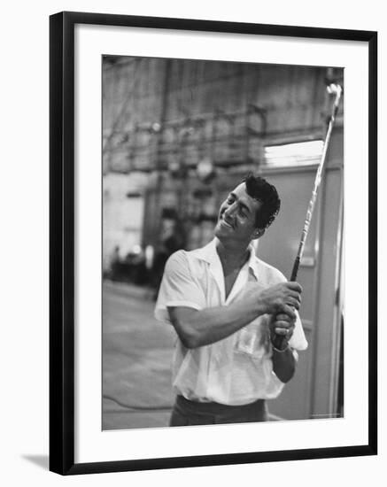 Singer and Actor Dean Martin holding a pitching club on Movie Set for MGM's "Some Came Running"-Allan Grant-Framed Premium Photographic Print