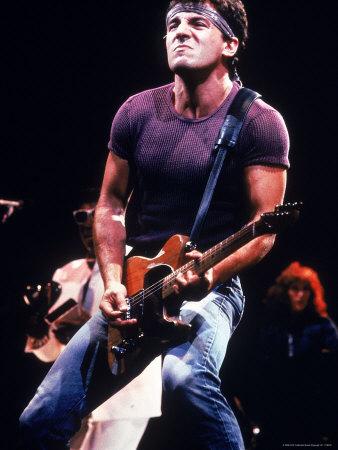 'Singer Bruce Springsteen Playing Guitar While Performing on Stage