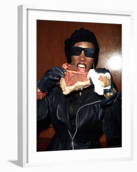 Singer Grace Jones Putting Raw Steak to Mouth-Marion Curtis-Framed Premium Photographic Print