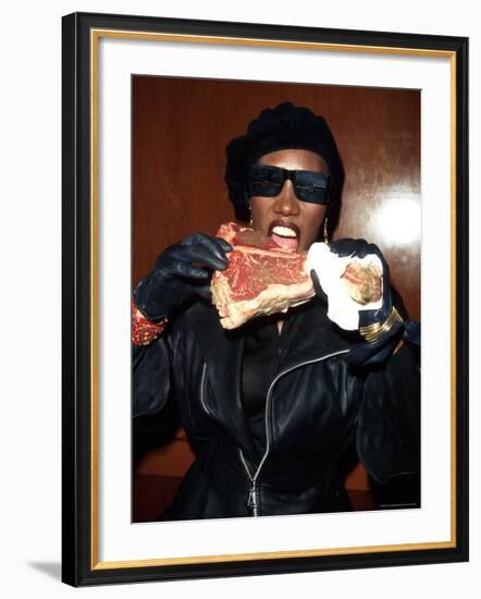 Singer Grace Jones Putting Raw Steak to Mouth-Marion Curtis-Framed Premium Photographic Print