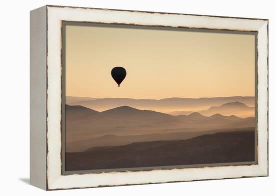 Single Hot Air Balloon over a Misty Dawn Sky, Cappadocia, Anatolia, Turkey, Asia Minor, Eurasia-David Clapp-Framed Premier Image Canvas