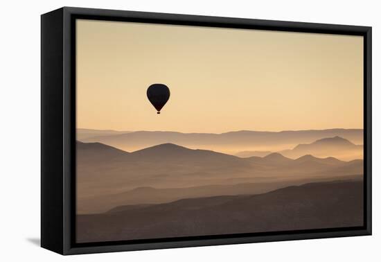 Single Hot Air Balloon over a Misty Dawn Sky, Cappadocia, Anatolia, Turkey, Asia Minor, Eurasia-David Clapp-Framed Premier Image Canvas